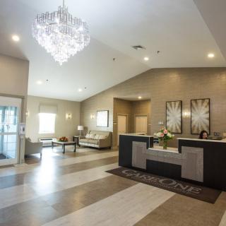 A modern lobby with a chandelier and a welcoming reception area.