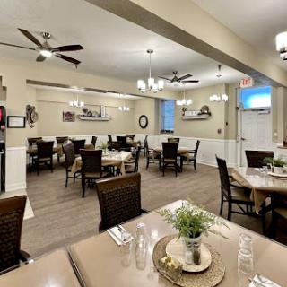A beautifully arranged dining room with modern decor and ample seating.