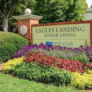 Eagles Landing Senior Living entrance with vibrant flower garden.