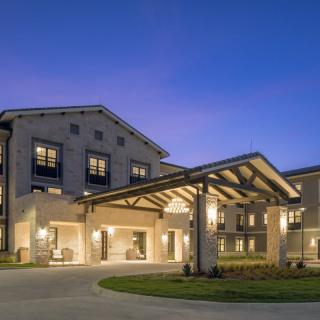 A modern building with a well-lit entrance at night.
