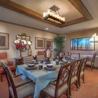 An elegantly designed dining room with a beautifully set table and stylish decor.