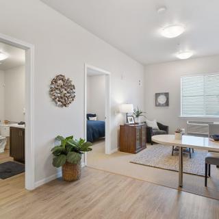 A modern living and dining area with elegant decor and wooden flooring.