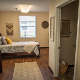 A cozy bedroom with warm decor and natural lighting.