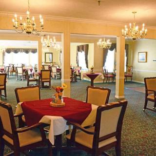 An elegant dining room with chandeliers and well-arranged tables.