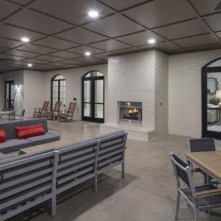 A modern living room featuring a spacious seating area with a fireplace, contemporary furniture, and stylish decor.