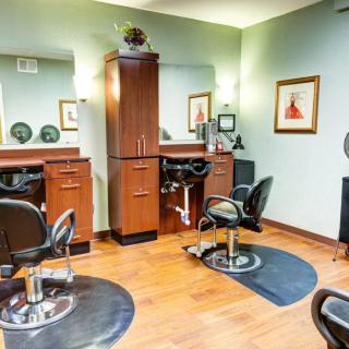 An interior view of a hair salon with styling stations and chairs.