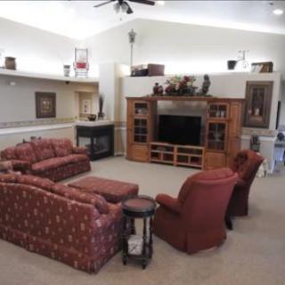 A cozy living room with comfortable seating and a large entertainment center.