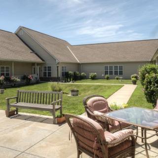 A peaceful courtyard with outdoor seating and a well-maintained garden.