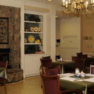A cozy dining room with elegant furniture and a chandelier.