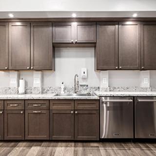 A modern kitchen with wooden cabinets and stainless steel appliances.