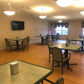 A spacious dining area with tables and chairs set for community gatherings.