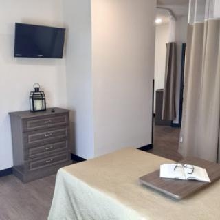 A serene and modern treatment room in a spa, featuring calming decor and essential amenities.