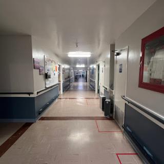 A quiet hallway in a healthcare facility, showcasing clean lines and bright lighting.
