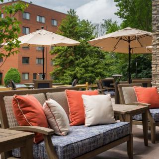 A cozy outdoor patio with cushioned seating and umbrellas, perfect for relaxation.