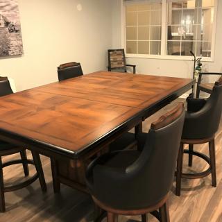 A spacious dining area featuring a large wooden table surrounded by comfortable chairs.