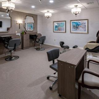 A modern beauty salon interior with stylish chairs, mirrors, and elegant lighting.