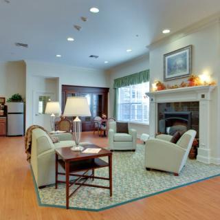 A cozy living room with comfortable seating and a warm fireplace.
