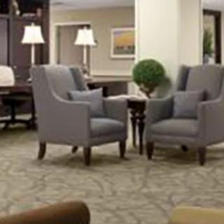 A cozy lobby area with armchairs and decorative elements.