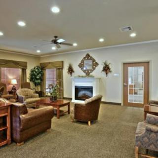 A cozy living room with a fireplace and comfortable seating.