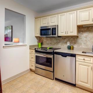 A modern kitchen featuring stainless steel appliances and light-colored cabinetry.
