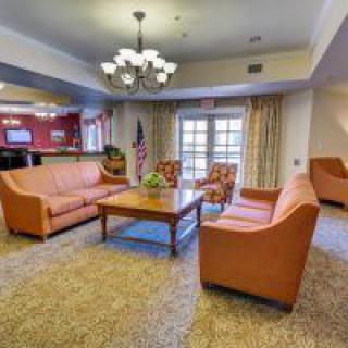A cozy living room with comfortable sofas and a chandelier.