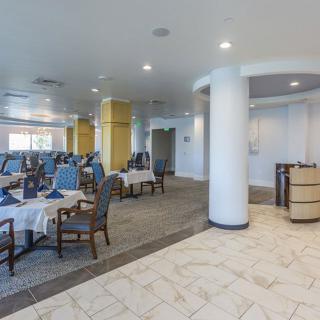 A modern restaurant dining area with neatly arranged tables and chairs.