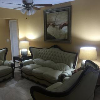 A cozy living room featuring classic sofas and warm lighting.