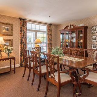 A traditional dining room with elegant furniture and decor.