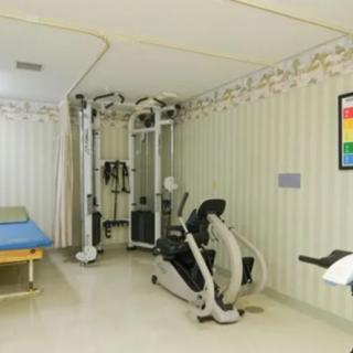 A physical therapy room equipped with fitness and exercise machines.