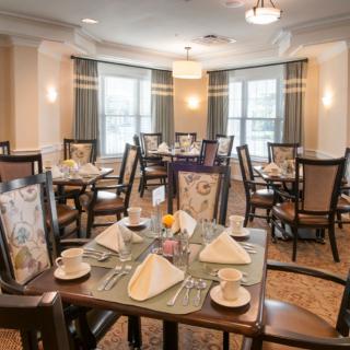 A well-arranged formal dining area with neatly set tables and chairs.