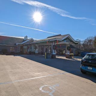 A sunny day showcasing a building with a parking lot under a bright sky.