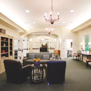 A cozy lounge area featuring comfortable seating and elegant lighting.