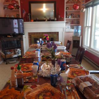 A dining table is set for a meal in a warmly decorated room.