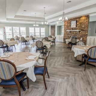 Elegant restaurant dining room with neatly arranged tables and chairs.