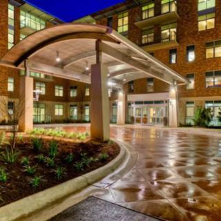A modern building entrance illuminated at night.