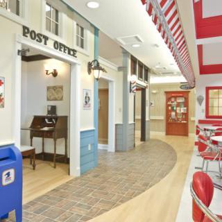 A vintage-themed indoor setting featuring a post office and a retro cafe.