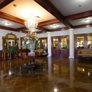 A luxurious lobby with a chandelier and elegant furnishings.