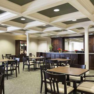 Spacious dining area with multiple tables and chairs, featuring elegant interior design.