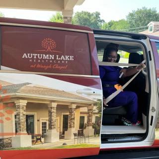 A person in a van with branding for Autumn Lake Healthcare, photographed with the door open.
