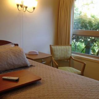 A cozy hotel room with a view outside the window.