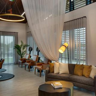 A modern and spacious lobby with elegant seating and decorative lighting.