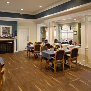 An elegant dining room with neatly arranged tables and chairs, featuring tasteful interior decor.