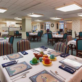 A well-set dining area with tables and chairs, ready for service in a restaurant or banquet setting.