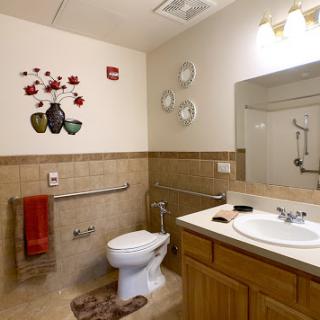 A well-organized bathroom featuring a toilet, sink, and decorative elements.
