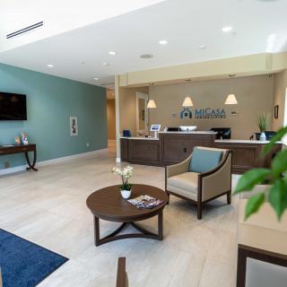 A modern lobby featuring a reception desk and comfortable seating area.