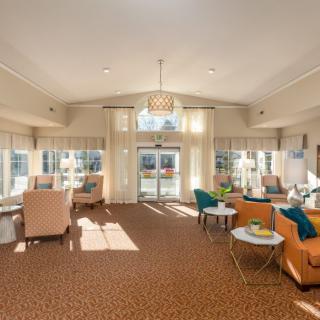 A spacious lobby with comfortable seating and large windows.