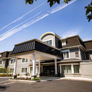 A modern residential building under a clear blue sky.