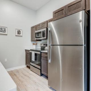 A modern kitchen featuring stainless steel appliances and sleek cabinets.