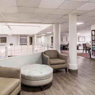 Modern office lobby with comfortable seating and open space.