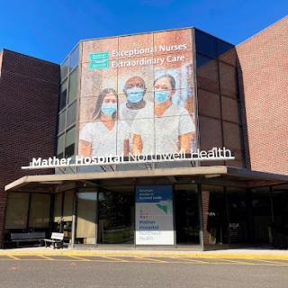 A healthcare facility featuring a mural of medical staff wearing masks, emphasizing community care.